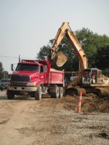 Excavation services- back hauler loading a truck