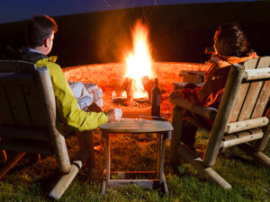 couple around a firepit in early fall